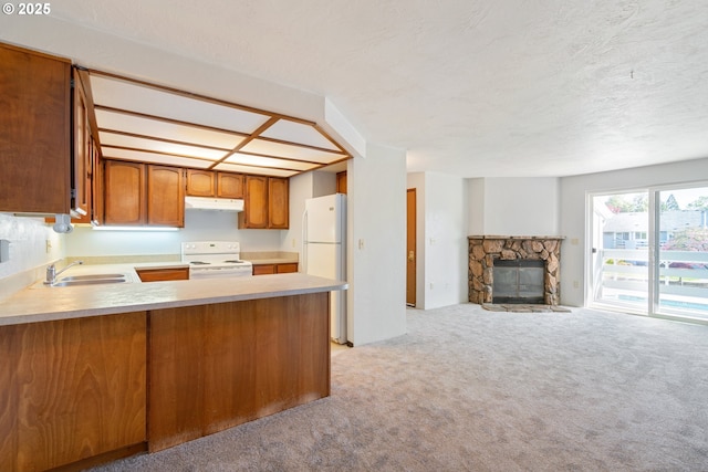 650 Harlow Rd Unit 240, Springfield, OR 97477 - kitchen with brown cabinets, under cabinet range hood, a sink, white appliances, and light colored carpet