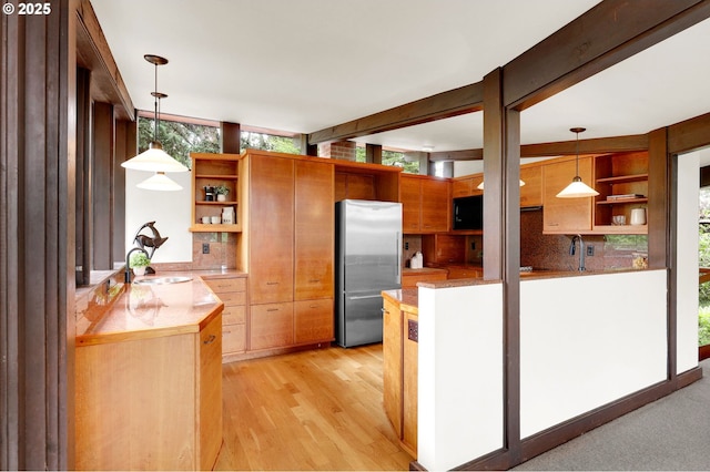 450 Horizon Rd, Eugene, OR 97405 - kitchen featuring open shelves, freestanding refrigerator, decorative backsplash, light countertops, and plenty of natural light