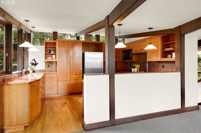 450 Horizon Rd, Eugene, OR 97405 - kitchen with open shelves, black microwave, stainless steel fridge, and decorative backsplash
