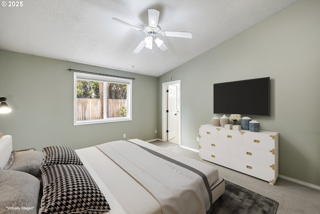 bedroom featuring ceiling fan, a textured ceiling, lofted ceiling, light colored carpet, and baseboards