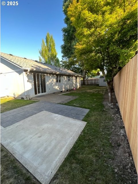 view of yard with a patio area and a fenced backyard