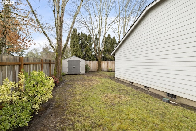 view of yard featuring a storage shed, a fenced backyard, and an outdoor structure