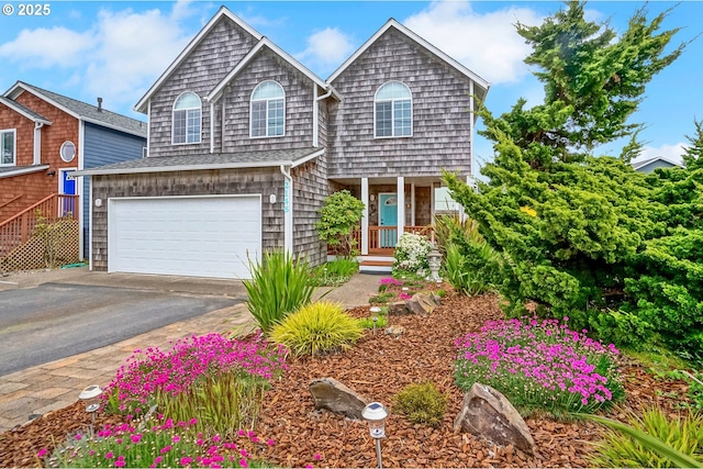 2146 NW Jetty Ave, Lincoln City, OR 97367 - view of front of home featuring driveway, an attached garage, and a porch
