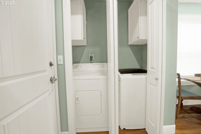 2146 NW Jetty Ave, Lincoln City, OR 97367 - laundry area featuring cabinet space, separate washer and dryer, and wood finished floors