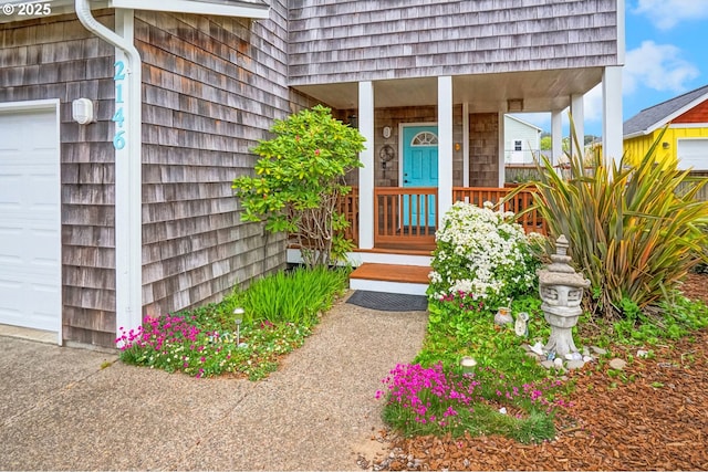 2146 NW Jetty Ave, Lincoln City, OR 97367 - view of exterior entry featuring a garage and covered porch