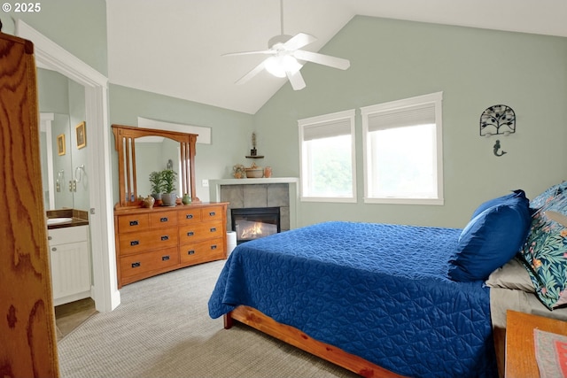 2146 NW Jetty Ave, Lincoln City, OR 97367 - bedroom with vaulted ceiling, a fireplace, carpet, ceiling fan, and ensuite bath