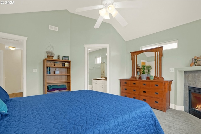 2146 NW Jetty Ave, Lincoln City, OR 97367 - carpeted bedroom with lofted ceiling, a fireplace, ceiling fan, and ensuite bathroom
