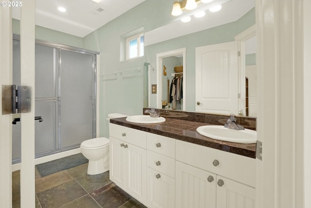 2146 NW Jetty Ave, Lincoln City, OR 97367 - full bathroom featuring a shower stall, toilet, a spacious closet, and double vanity