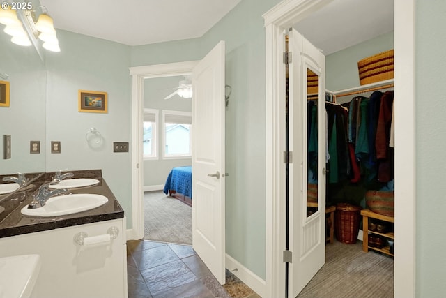 2146 NW Jetty Ave, Lincoln City, OR 97367 - bathroom featuring connected bathroom, baseboards, a walk in closet, and double vanity