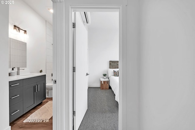 bathroom featuring vanity, a wall mounted air conditioner, and toilet