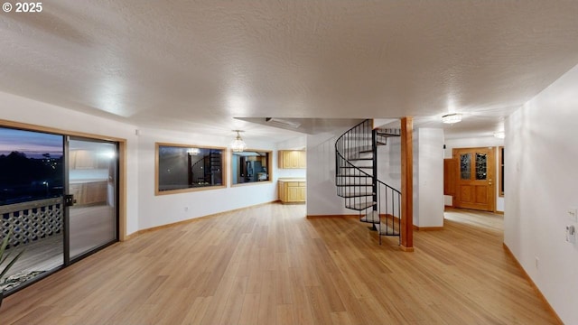 living room featuring light hardwood / wood-style flooring and a textured ceiling