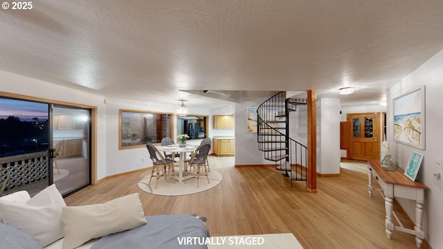 16151 Lower Harbor Rd, Brookings, OR 97415 - living room featuring stairs, baseboards, a textured ceiling, and light wood-style floors