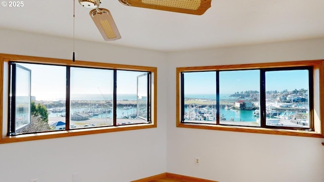 unfurnished room featuring a water view