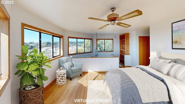 16151 Lower Harbor Rd, Brookings, OR 97415 - bedroom with a ceiling fan, multiple windows, wood finished floors, and baseboards