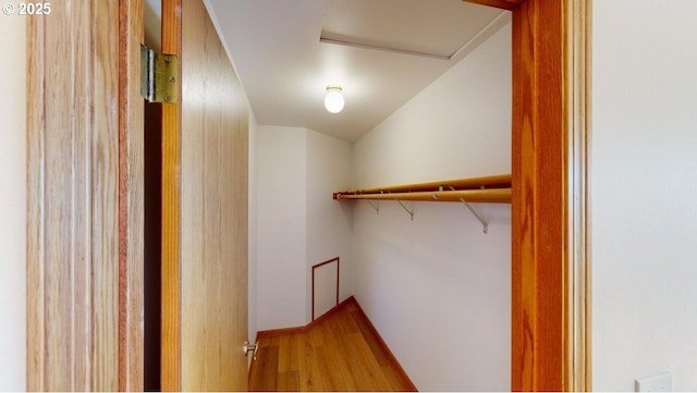 16151 Lower Harbor Rd, Brookings, OR 97415 - walk in closet with wood finished floors, attic access, and vaulted ceiling