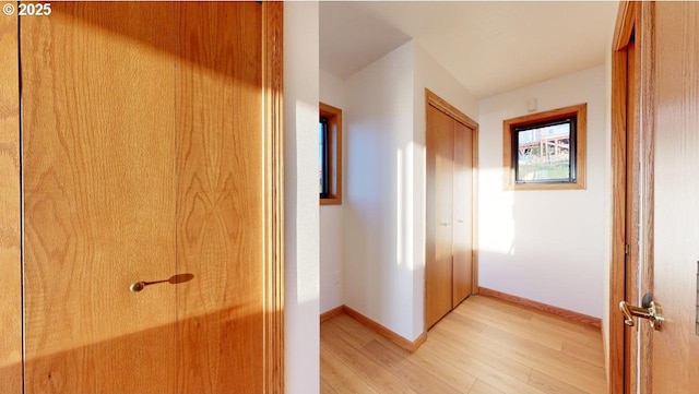 corridor with light wood-type flooring