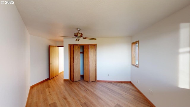 spare room with light hardwood / wood-style flooring and ceiling fan