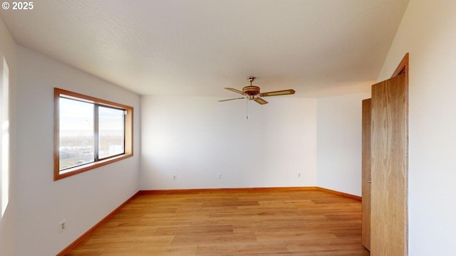 unfurnished room featuring ceiling fan and light wood-type flooring