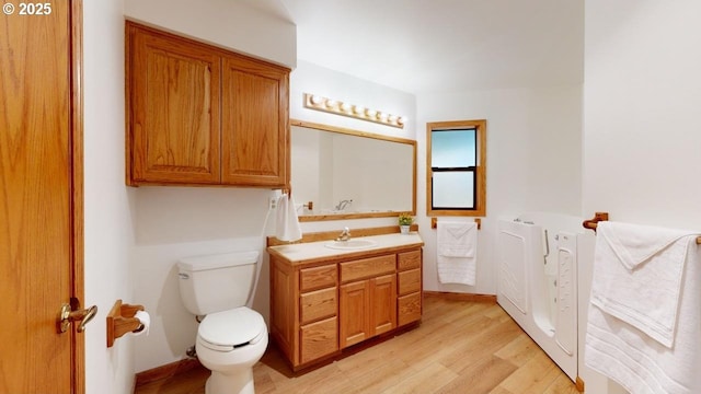 16151 Lower Harbor Rd, Brookings, OR 97415 - bathroom featuring toilet, vanity, and wood finished floors