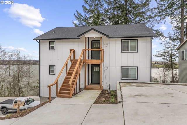 view of front facade featuring board and batten siding and a shingled roof