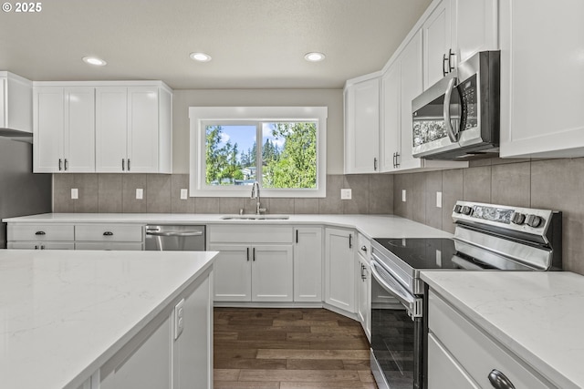 151 Alpha Dr, Longview, WA 98632 - kitchen featuring stainless steel appliances, a sink, dark wood finished floors, light stone counters, and recessed lighting
