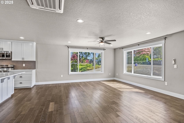 151 Alpha Dr, Longview, WA 98632 - unfurnished living room with ceiling fan, dark wood finished floors, a textured ceiling, baseboards, and recessed lighting