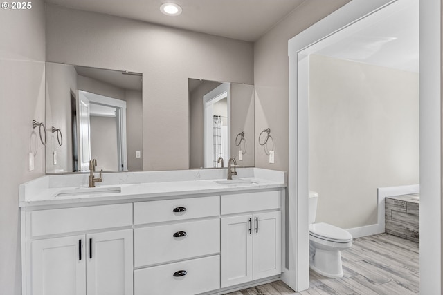 151 Alpha Dr, Longview, WA 98632 - bathroom with toilet, double vanity, wood finished floors, and baseboards
