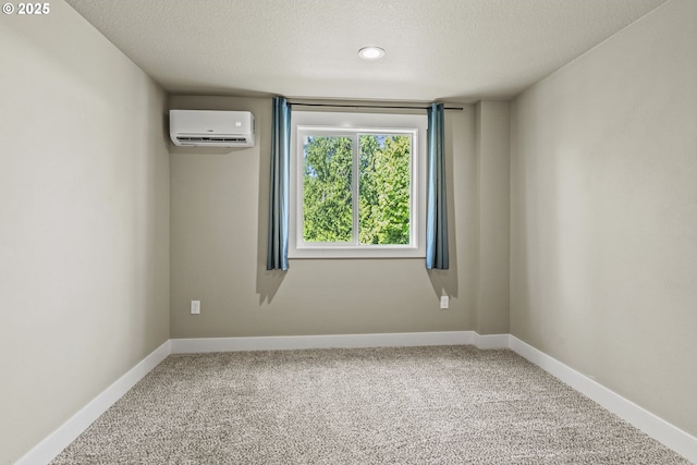 151 Alpha Dr, Longview, WA 98632 - carpeted empty room with an AC wall unit, a textured ceiling, and baseboards
