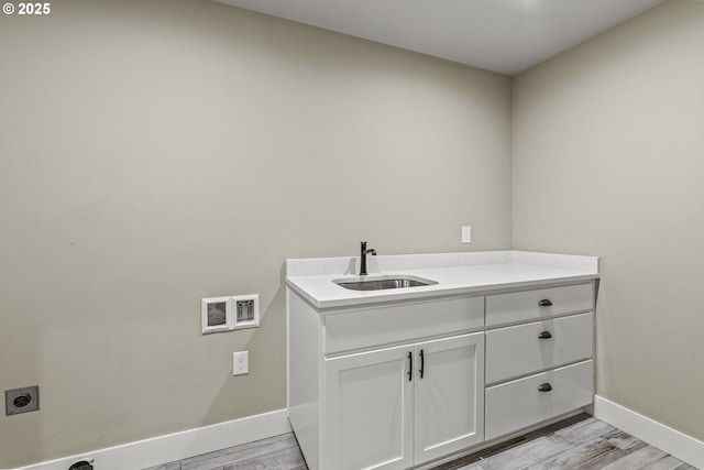 151 Alpha Dr, Longview, WA 98632 - laundry area with hookup for an electric dryer, baseboards, washer hookup, light wood-style floors, and cabinet space