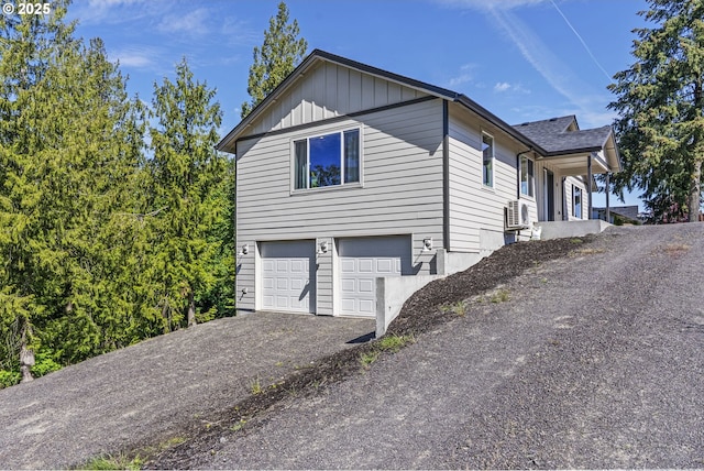 151 Alpha Dr, Longview, WA 98632 - view of side of home featuring a garage, asphalt driveway, and board and batten siding