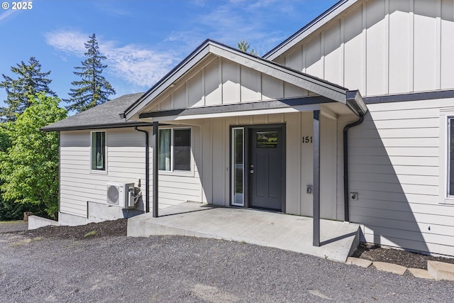 151 Alpha Dr, Longview, WA 98632 - doorway to property featuring board and batten siding, a shingled roof, and a cooling unit