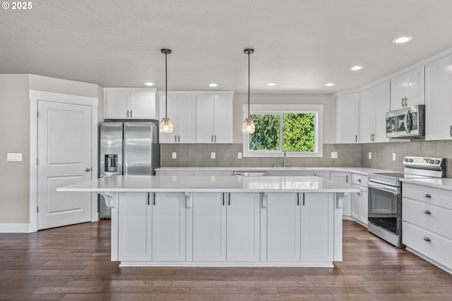 151 Alpha Dr, Longview, WA 98632 - kitchen featuring appliances with stainless steel finishes, a center island, white cabinets, light countertops, and recessed lighting