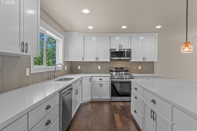 151 Alpha Dr, Longview, WA 98632 - kitchen with stainless steel appliances, a sink, dark wood finished floors, white cabinetry, and recessed lighting