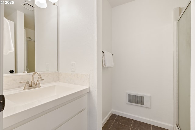 full bathroom with tile patterned flooring, a shower stall, vanity, and baseboards