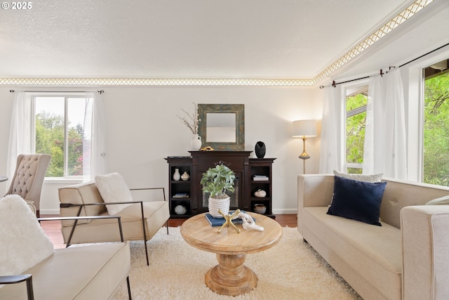 living area with wood finished floors and baseboards