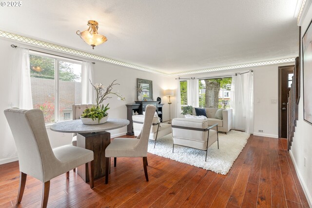 dining space with wood finished floors and baseboards