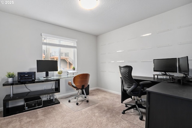 carpeted office space with baseboards and a textured ceiling