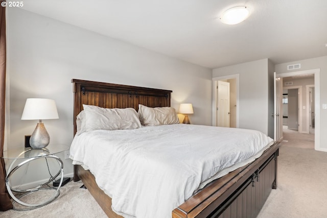 bedroom featuring light carpet, visible vents, and baseboards