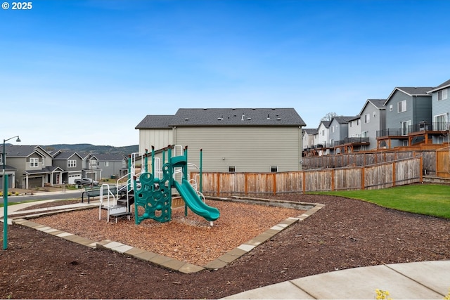 view of play area with a residential view and fence