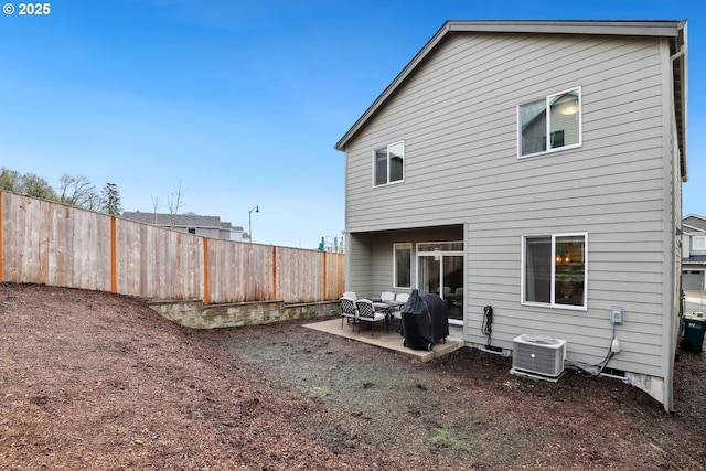 back of property featuring a patio area, fence, and central AC