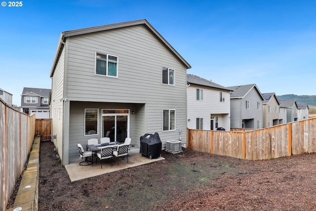 rear view of property featuring a patio and a fenced backyard