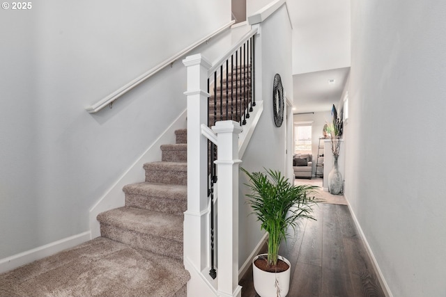 stairs featuring baseboards and wood finished floors