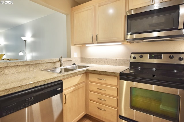 1500 SW Park Ave Unit 206, Portland, OR 97201 - kitchen with appliances with stainless steel finishes, light brown cabinets, and a sink