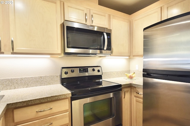 1500 SW Park Ave Unit 206, Portland, OR 97201 - kitchen featuring appliances with stainless steel finishes and light brown cabinetry