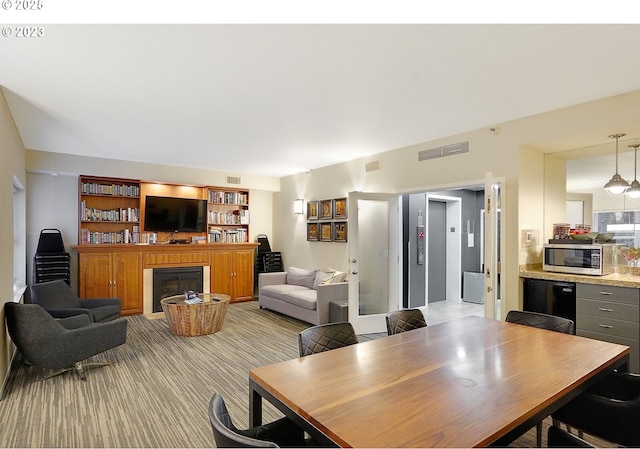 1500 SW Park Ave Unit 206, Portland, OR 97201 - dining area featuring a glass covered fireplace