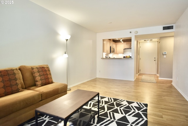 1500 SW Park Ave Unit 206, Portland, OR 97201 - living area featuring light wood-style floors and baseboards