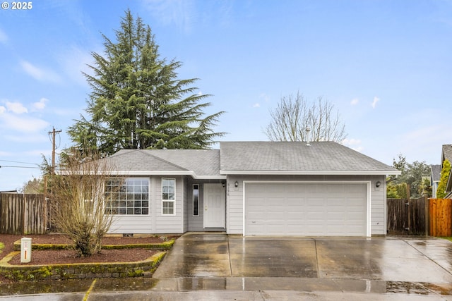 ranch-style home featuring a shingled roof, fence, driveway, and an attached garage