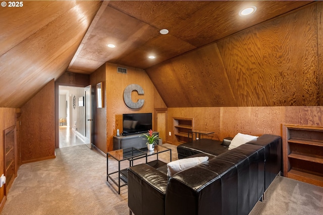 interior space featuring vaulted ceiling, wooden walls, visible vents, and recessed lighting