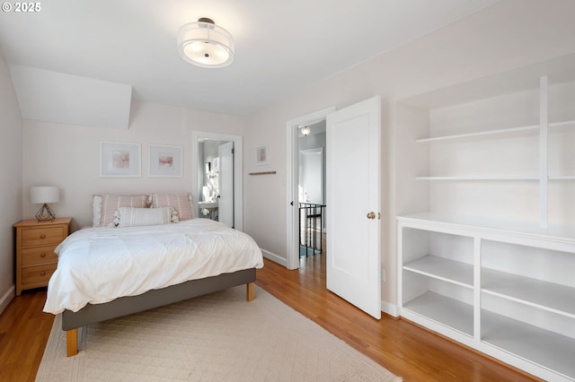 bedroom featuring baseboards and wood finished floors