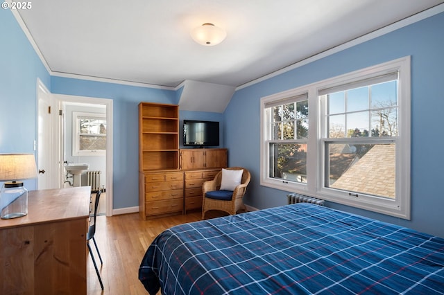 bedroom with baseboards, radiator heating unit, light wood-type flooring, and crown molding